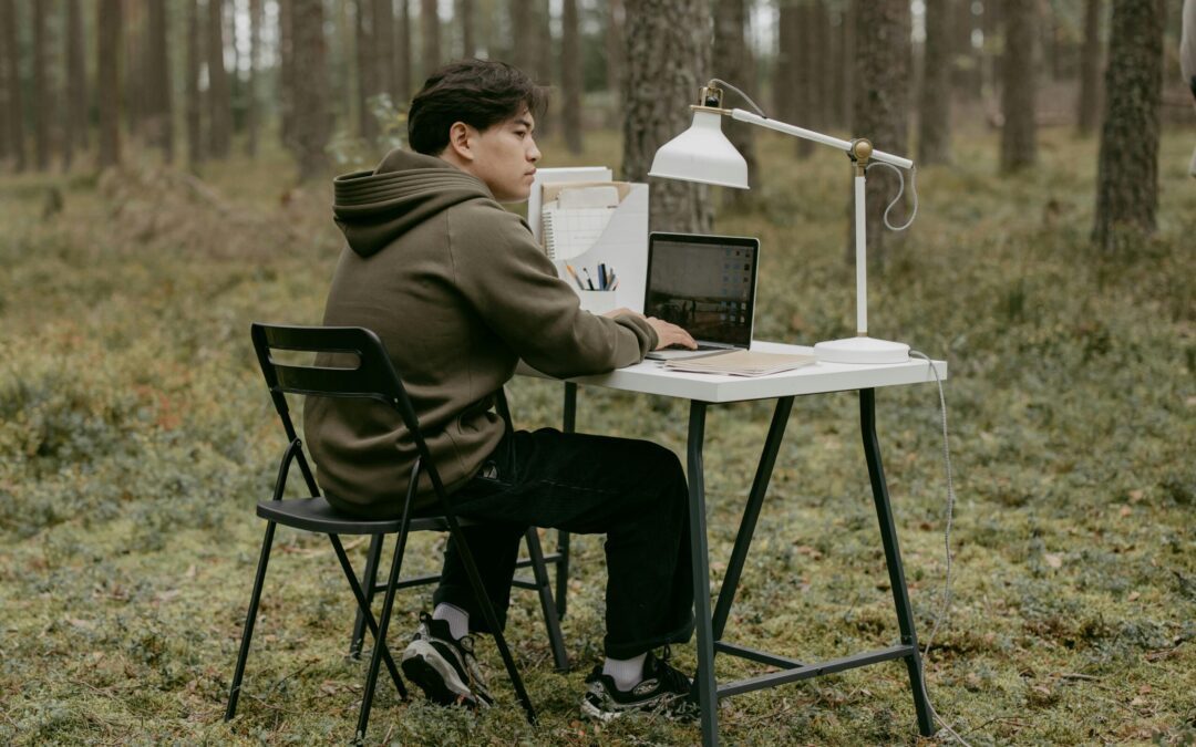 Man working remotely at a desk in the forest