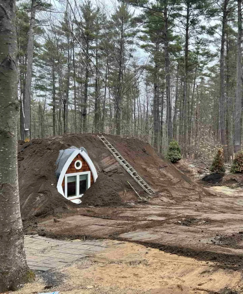 Soil being placed around the curved shell of Fern Hollow during construction.