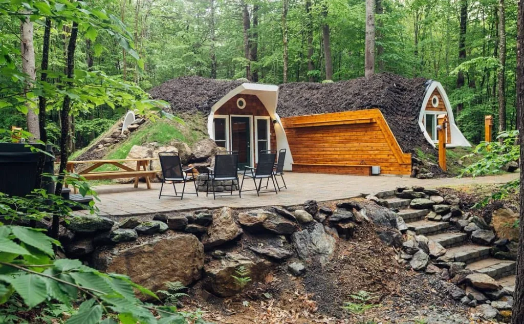 Fern Hollow stone patio and hot tub overlooking a quiet Maine lake.